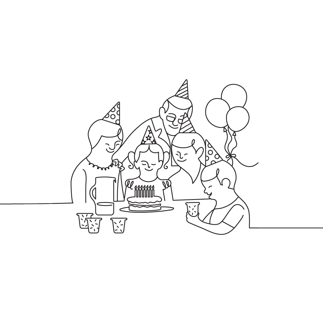 Family celebrating a birthday with balloons and cake white.